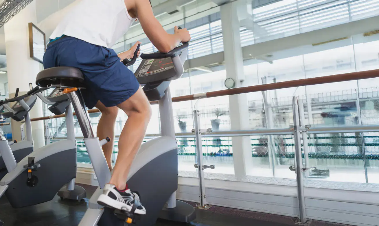 Man working out on a bike in a gym